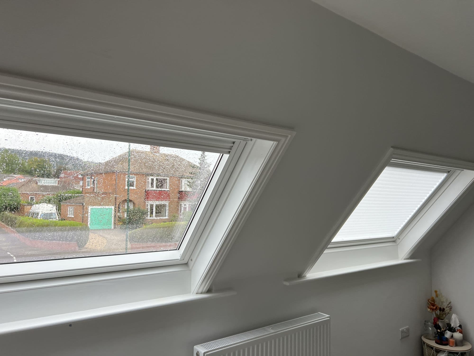 Bright loft room with two white-framed roof windows